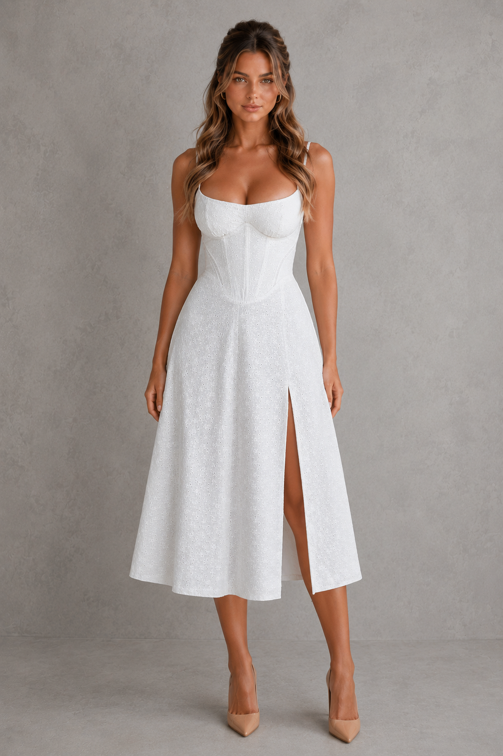 Woman wearing a white dress with a slit on a gray background