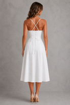 White dress with thin straps on a gray background