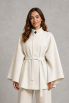 Women's elegant wool-blend cape sleeve coat with stand collar, slim tailored fit and belted waist, ideal for autumn and winter formal wear.