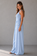 Woman wearing a light blue dress against a plain background