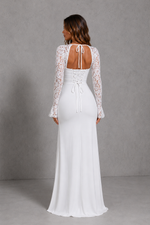 White lace wedding dress with long sleeves on a gray background