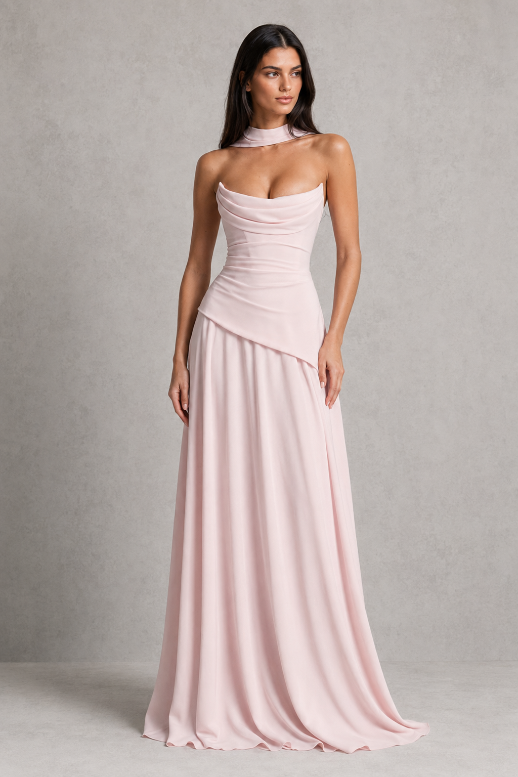 Woman wearing a pink strapless gown against a gray background