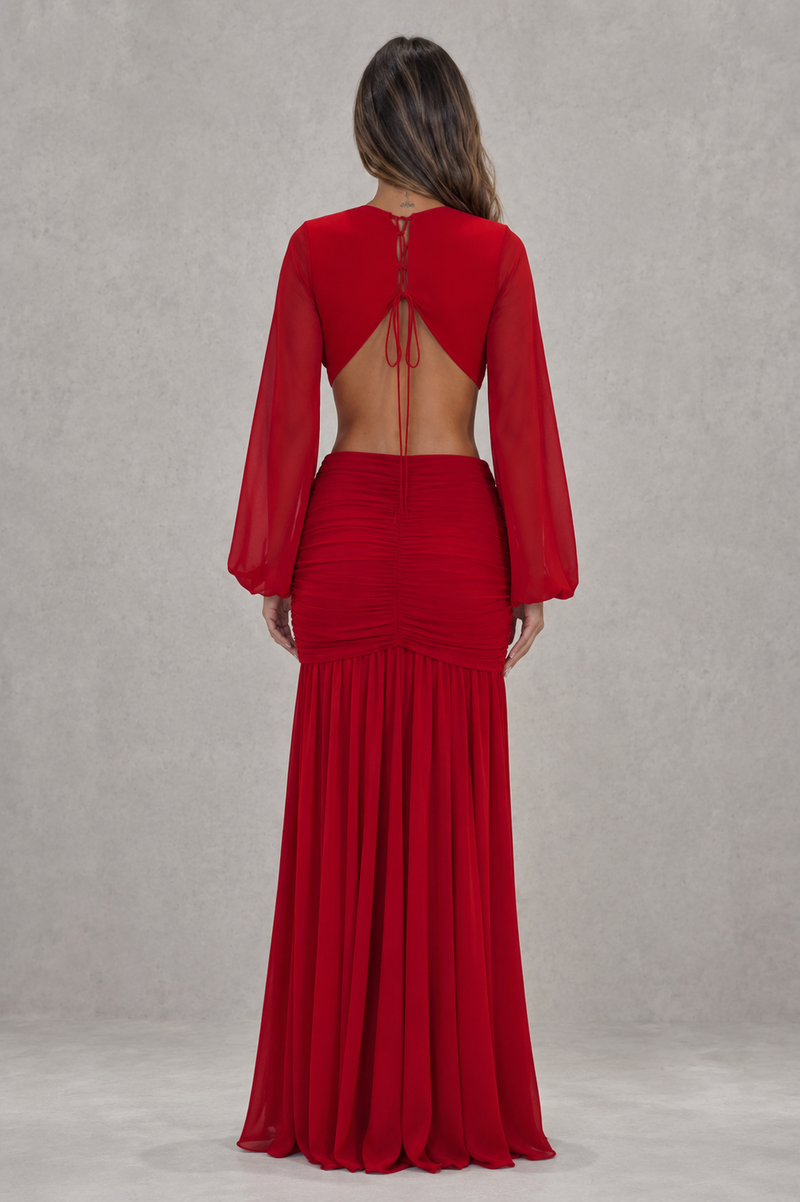 Red evening gown with long sleeves and open back on a plain background
