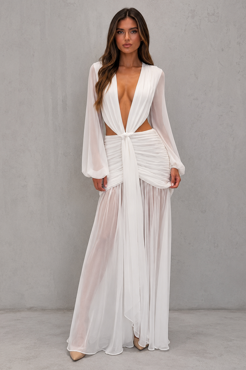 Woman wearing a white, sheer outfit against a gray background