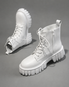 Women's black chunky sole combat boots with lace-up fastening, ankle-height design, round toe, medium square heel and durable rubber sole for casual everyday wear.