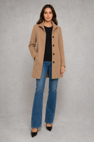 Women’s classic button-front coat with an elegant straight fit, long sleeves and a timeless design for autumn and spring wear.