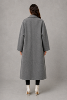 Women’s classic wool maxi coat with a relaxed longline silhouette, minimalist styling and traditional front button fastening for autumn and winter.