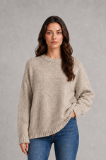 Light grey women’s crew neck knit jumper with an oversized relaxed fit, dropped shoulders and loose wide long sleeves.
