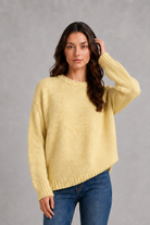 Light grey women’s crew neck knit jumper with an oversized relaxed fit, dropped shoulders and loose wide long sleeves.