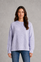 Light grey women’s crew neck knit jumper with an oversized relaxed fit, dropped shoulders and loose wide long sleeves.