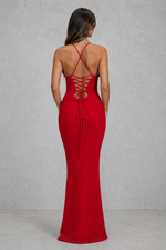 Red evening gown with open back on a plain background