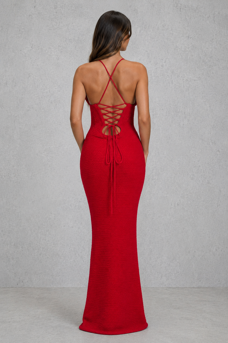 Red evening gown with open back on a plain background