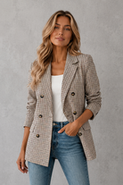 Women's double-breasted plaid blazer with a tailored fit, lapel collar, long sleeves and classic check pattern for work and smart casual occasions.