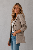Women's double-breasted plaid blazer with a tailored fit, lapel collar, long sleeves and classic check pattern for work and smart casual occasions.