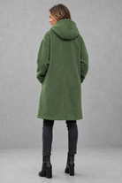 Women's elegant button-front autumn and winter coat with a relaxed fit, classic longline silhouette, soft warm fabric, long sleeves and timeless design, ideal for layering with knitwear, dresses or tailored outfits.