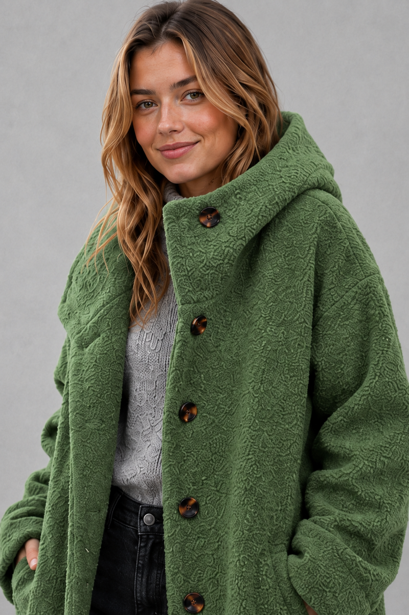 Women's elegant button-front autumn and winter coat with a relaxed fit, classic longline silhouette, soft warm fabric, long sleeves and timeless design, ideal for layering with knitwear, dresses or tailored outfits.