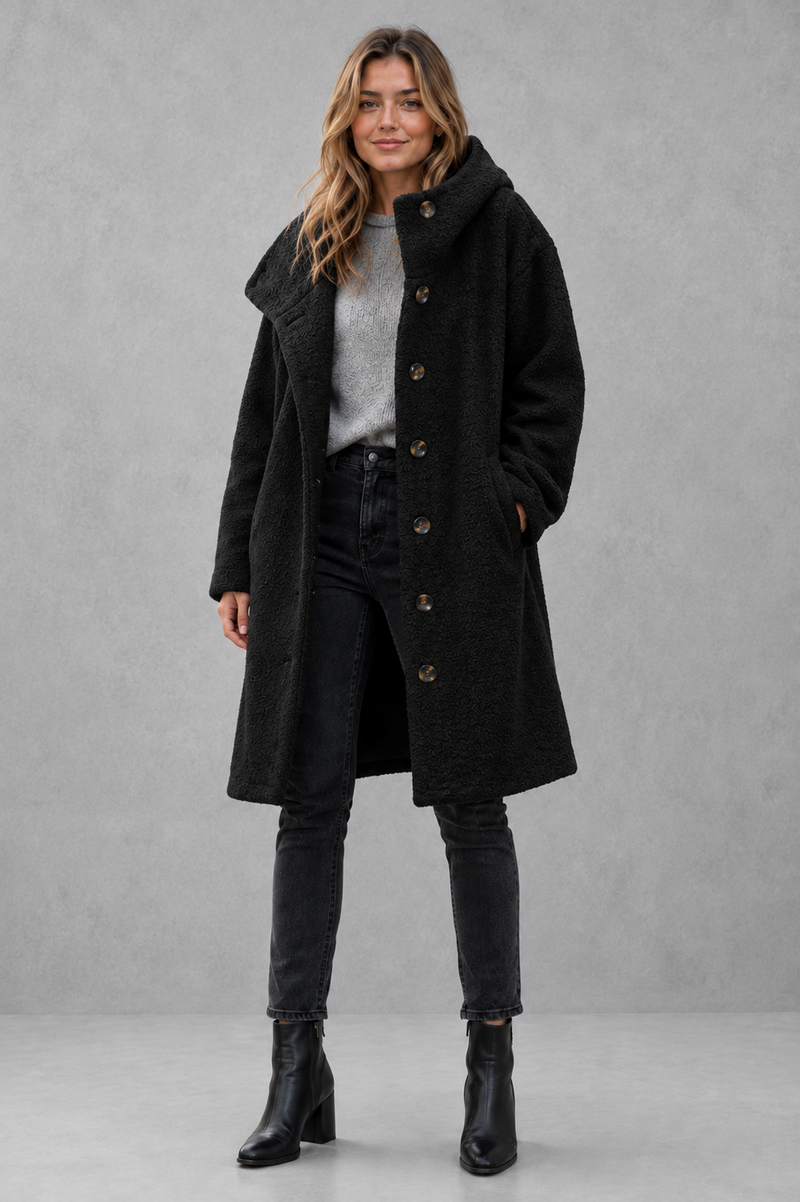 Women's elegant button-front autumn and winter coat with a relaxed fit, classic longline silhouette, soft warm fabric, long sleeves and timeless design, ideal for layering with knitwear, dresses or tailored outfits.