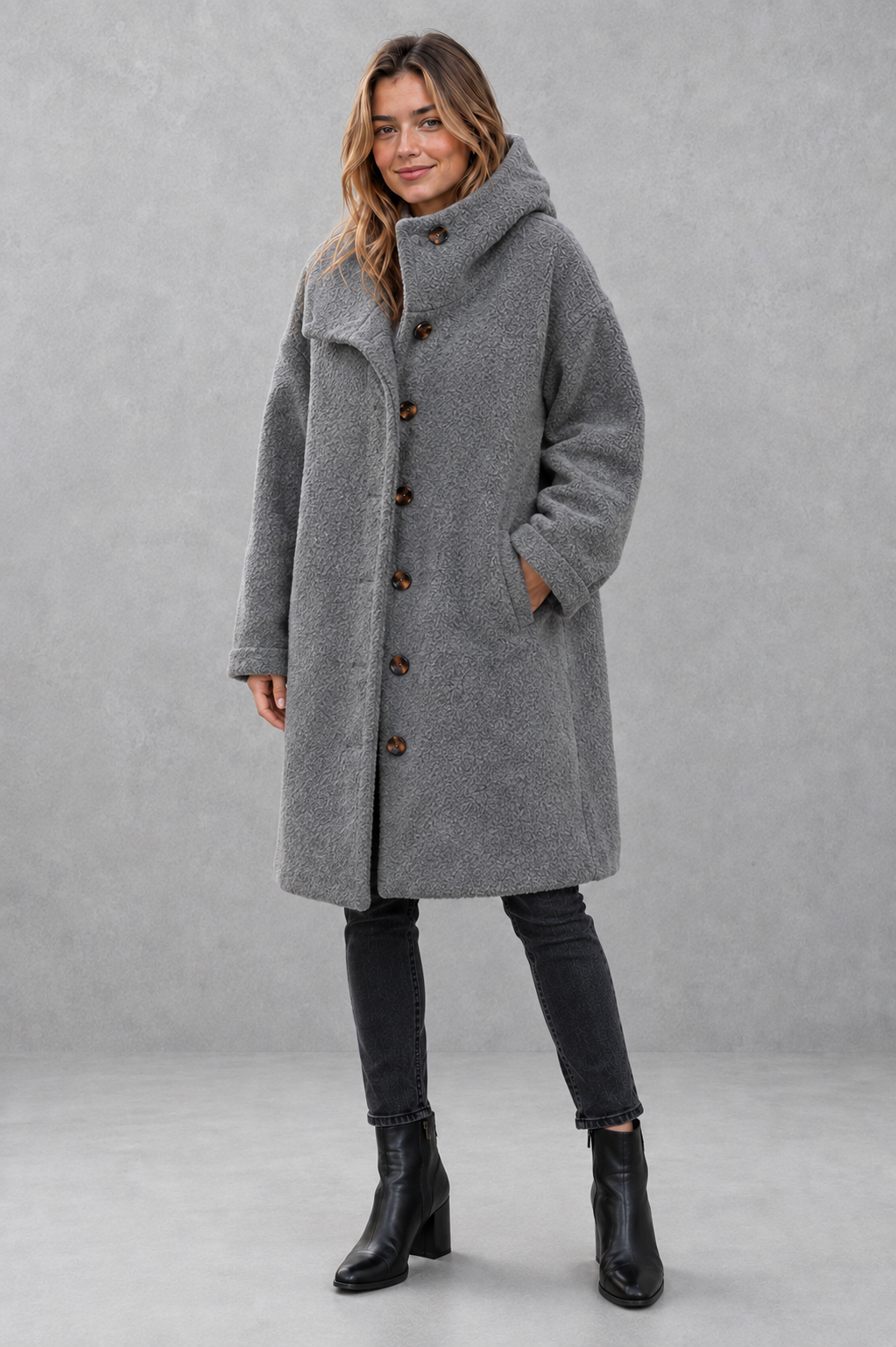 Women's elegant button-front autumn and winter coat with a relaxed fit, classic longline silhouette, soft warm fabric, long sleeves and timeless design, ideal for layering with knitwear, dresses or tailored outfits.