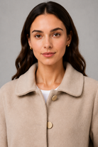 Women’s elegant oversized mid-length coat with spacious pockets and refined cuff detailing, designed for stylish autumn and winter layering.