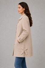 Women’s elegant oversized mid-length coat with spacious pockets and refined cuff detailing, designed for stylish autumn and winter layering.