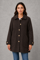 Women’s elegant oversized mid-length coat with spacious pockets and refined cuff detailing, designed for stylish autumn and winter layering.
