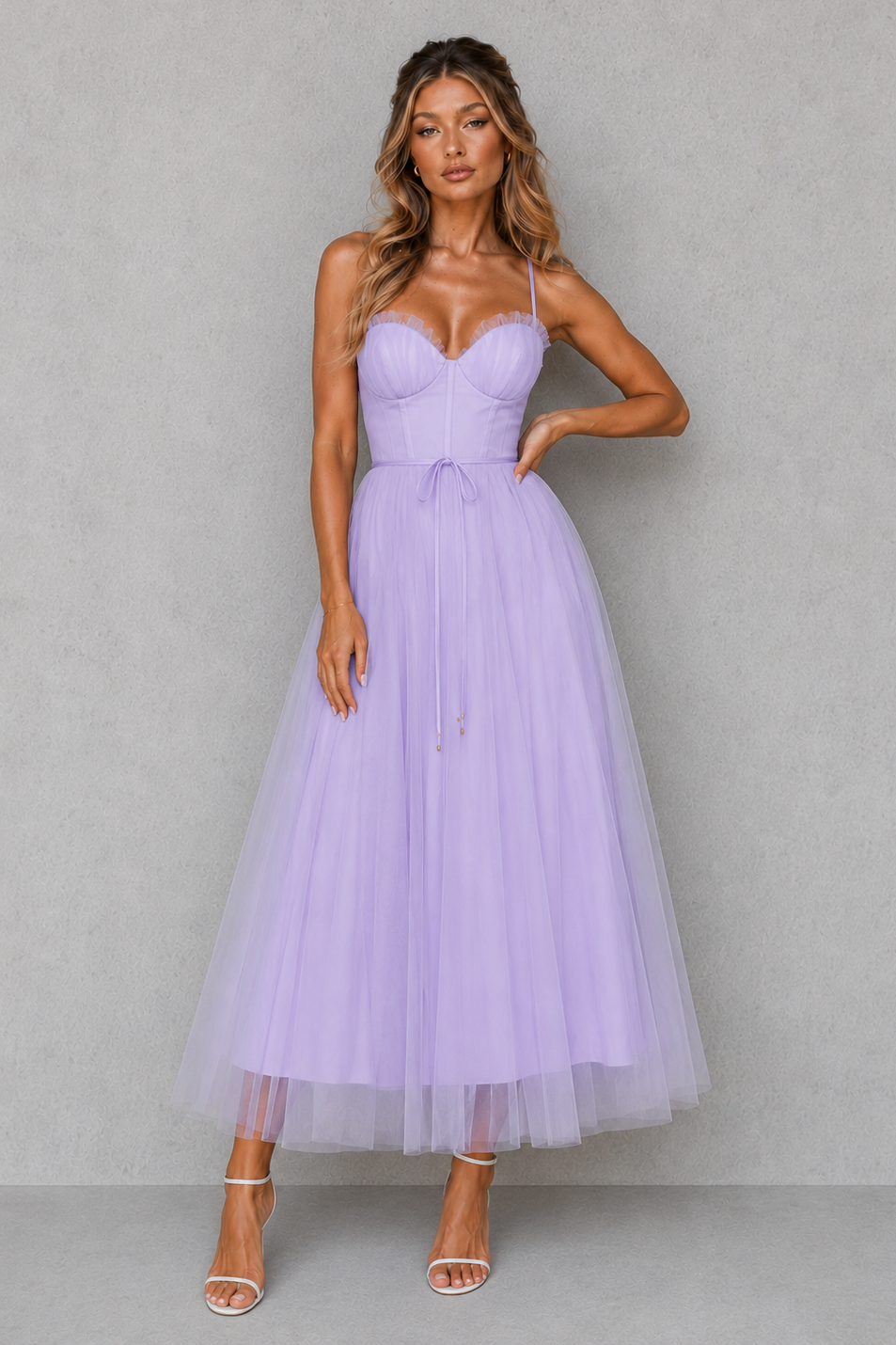 Woman wearing a lavender dress against a gray background