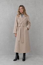 Women's elegant wrap coat in a longline design with a tailored lapel collar and adjustable matching waist belt, offering a flattering regular fit and lightweight warmth for autumn and winter wear.