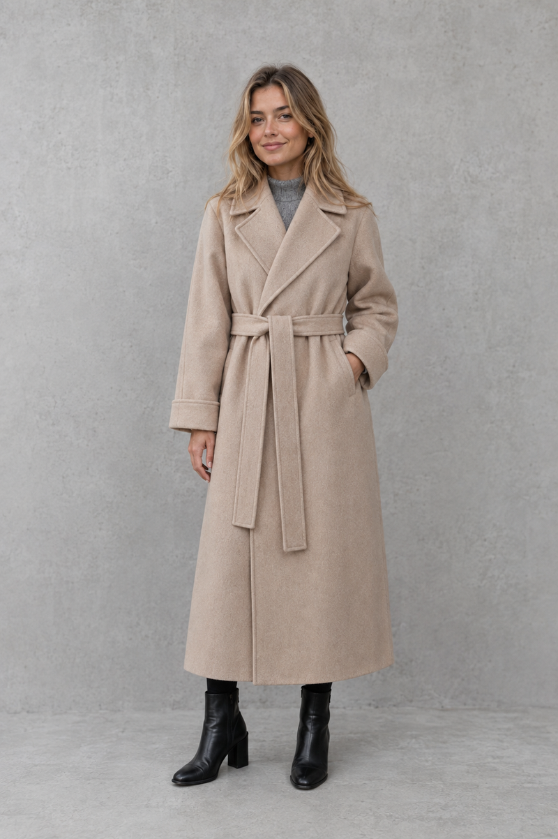 Women's elegant wrap coat in a longline design with a tailored lapel collar and adjustable matching waist belt, offering a flattering regular fit and lightweight warmth for autumn and winter wear.