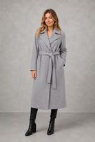 Women's elegant wrap coat in a longline design with a tailored lapel collar and adjustable matching waist belt, offering a flattering regular fit and lightweight warmth for autumn and winter wear.