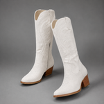 Women's embroidered western cowboy boots in a knee-high design with a soft suede-look finish, decorative stitching, mid-height heel, side zip fastening and durable TPR sole, ideal for everyday autumn and winter wear.