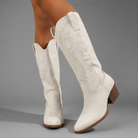 Women's embroidered western cowboy boots in a knee-high design with a soft suede-look finish, decorative stitching, mid-height heel, side zip fastening and durable TPR sole, ideal for everyday autumn and winter wear.