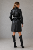 Women's long faux leather trench coat with a slim-fit silhouette, belted waist, lapel collar and soft faux fur lining, available in black, brown, rose red and wine red.