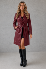 Women's long faux leather trench coat with a slim-fit silhouette, belted waist, lapel collar and soft faux fur lining, available in black, brown, rose red and wine red.