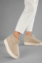Women's faux suede platform snow boots with a soft faux fur lining, slip-on ankle-height design, round toe, back pull tab, 1.75-inch platform sole and non-slip outsole for warm, comfortable winter everyday wear.