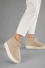 Women's faux suede platform snow boots with a soft faux fur lining, slip-on ankle-height design, round toe, back pull tab, 1.75-inch platform sole and non-slip outsole for warm, comfortable winter everyday wear.