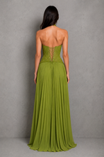 Woman wearing a green strapless gown against a gray background