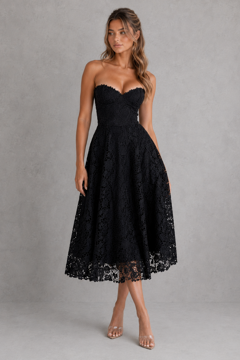 Woman wearing a black lace strapless dress against a gray background