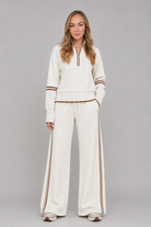 Women's half zip lounge set featuring a relaxed fit sweatshirt with a funnel neckline, contrast stripe detailing, and matching wide leg trousers with an elasticated drawstring waistband in soft stretch fabric.