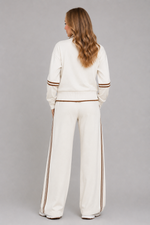 Women's half zip lounge set featuring a relaxed fit sweatshirt with a funnel neckline, contrast stripe detailing, and matching wide leg trousers with an elasticated drawstring waistband in soft stretch fabric.
