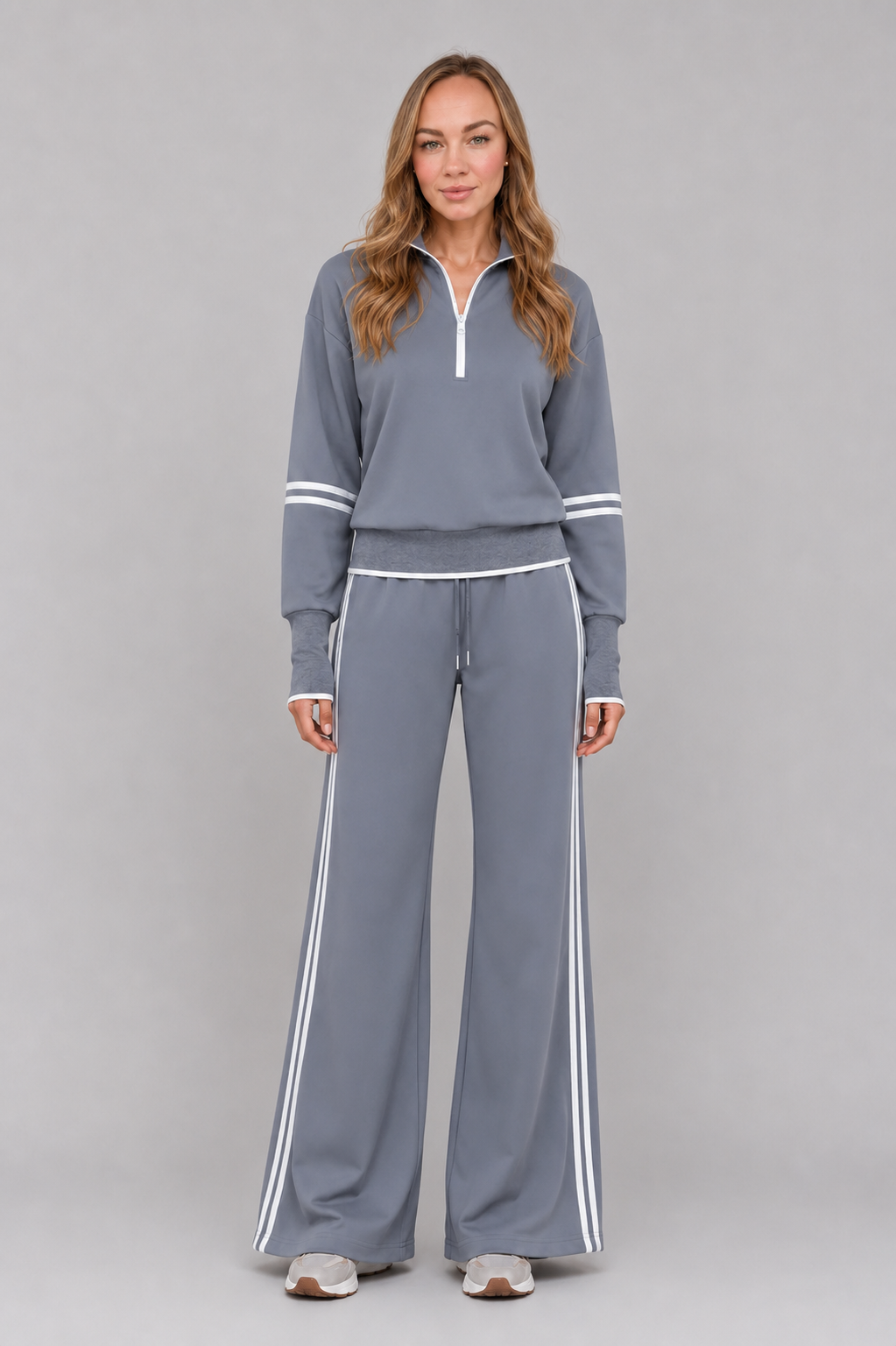 Women's half zip lounge set featuring a relaxed fit sweatshirt with a funnel neckline, contrast stripe detailing, and matching wide leg trousers with an elasticated drawstring waistband in soft stretch fabric.