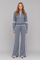 Women's half zip lounge set featuring a relaxed fit sweatshirt with a funnel neckline, contrast stripe detailing, and matching wide leg trousers with an elasticated drawstring waistband in soft stretch fabric.