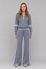 Women's half zip lounge set featuring a relaxed fit sweatshirt with a funnel neckline, contrast stripe detailing, and matching wide leg trousers with an elasticated drawstring waistband in soft stretch fabric.