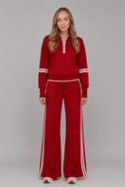 Women's half zip lounge set featuring a relaxed fit sweatshirt with a funnel neckline, contrast stripe detailing, and matching wide leg trousers with an elasticated drawstring waistband in soft stretch fabric.