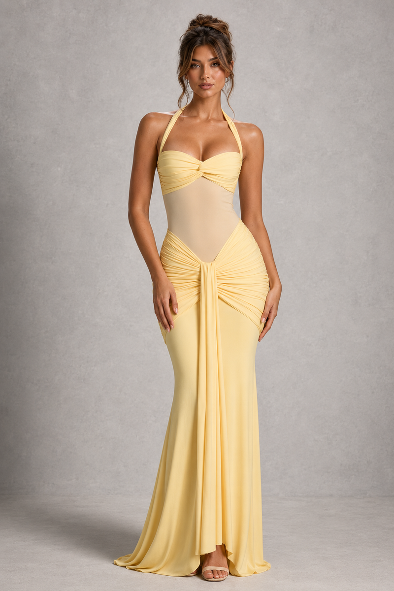 Woman wearing a yellow evening gown against a gray background