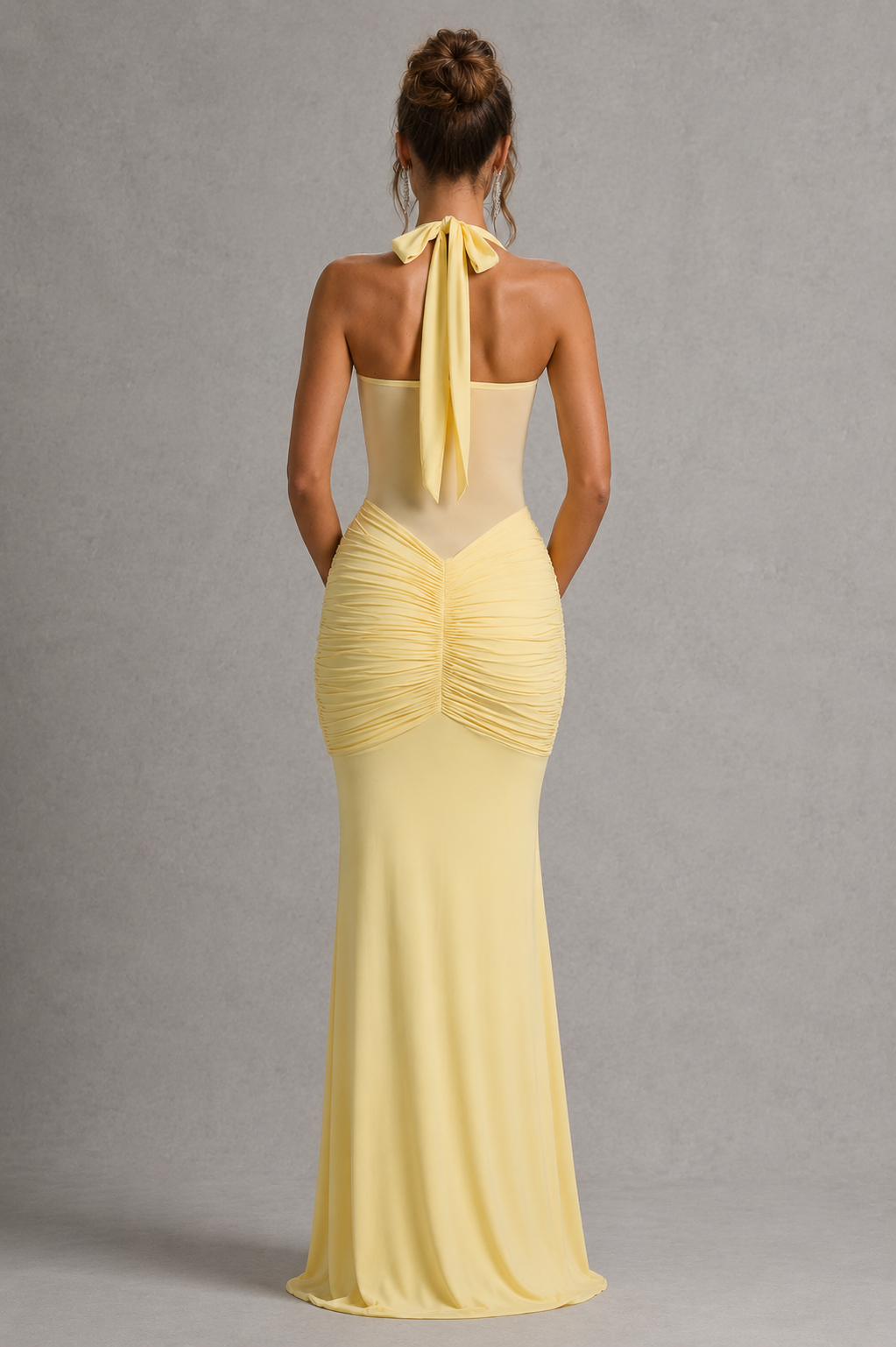 Yellow evening gown with a plain gray background