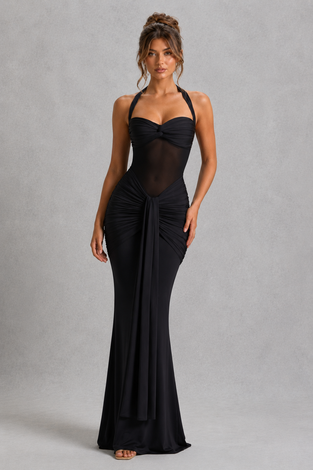 Woman wearing a black evening gown against a gray background