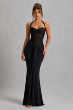 Woman wearing a black evening gown against a gray background