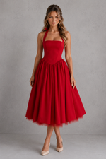 Woman wearing a red dress against a gray background