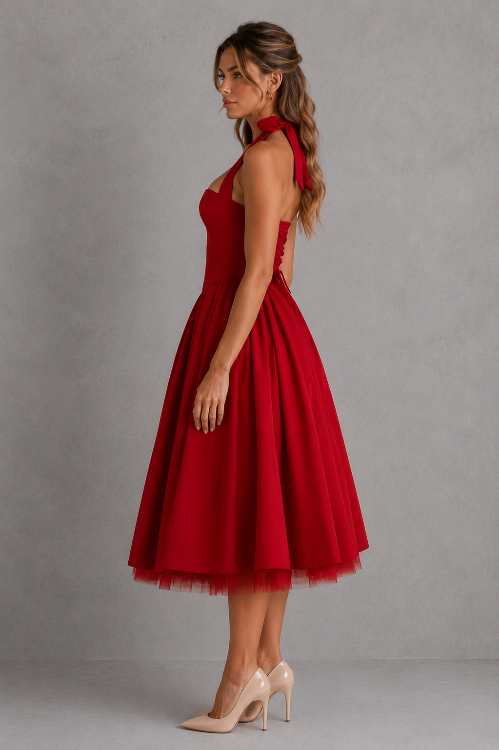 Woman wearing a red dress against a gray background