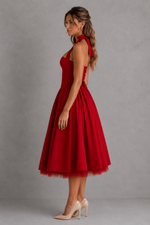 Woman wearing a red dress against a gray background
